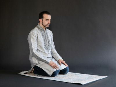 Person meditating in a dark studio setting
